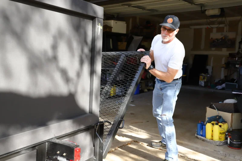 Sean, owner of North Austin Junk Removal, loading his trailer